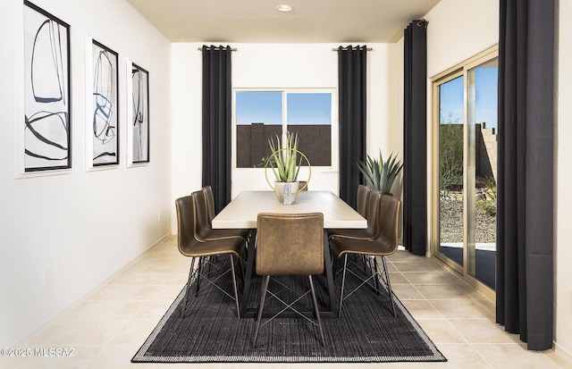 dining space featuring recessed lighting and light tile patterned flooring