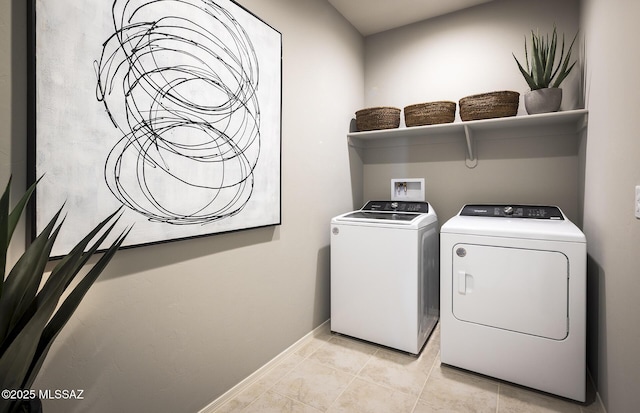 laundry room with laundry area, baseboards, light tile patterned floors, and washing machine and clothes dryer