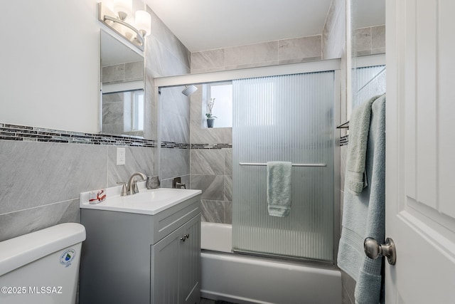 4825 E Hawthorne St, Tucson, AZ 85711 - bathroom with tile walls, vanity, and combined bath / shower with glass door