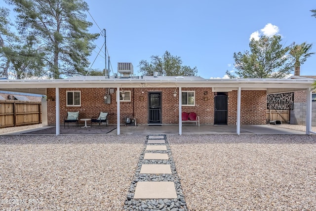 4825 E Hawthorne St, Tucson, AZ 85711 - rear view of house with a patio and brick siding