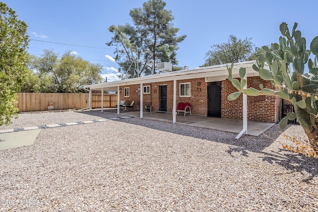4825 E Hawthorne St, Tucson, AZ 85711 - back of house with a patio and brick siding