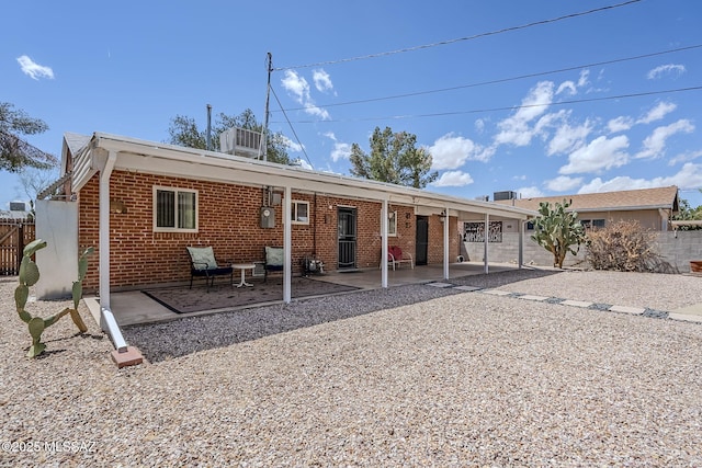 4825 E Hawthorne St, Tucson, AZ 85711 - rear view of house featuring a patio and brick siding