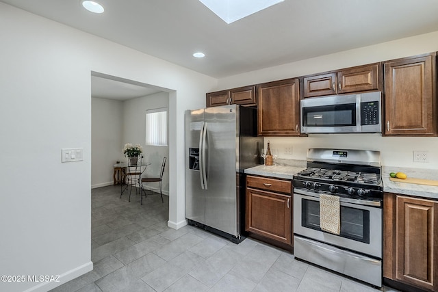 4825 E Hawthorne St, Tucson, AZ 85711 - kitchen with stainless steel appliances, recessed lighting, a skylight, and light tile patterned flooring