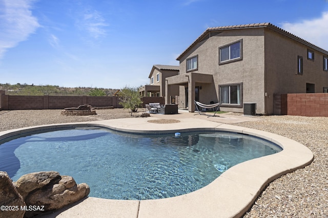 view of pool with a fenced in pool, a fenced backyard, a patio area, and a fire pit