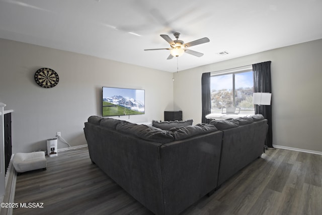 living room featuring visible vents, dark wood-style flooring, ceiling fan, and baseboards