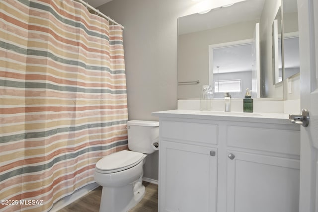 full bath with vanity, curtained shower, toilet, and wood finished floors