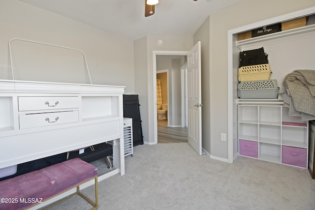 sitting room with baseboards, a ceiling fan, and carpet flooring