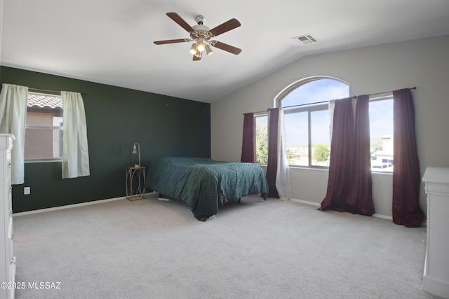 carpeted bedroom with baseboards, a ceiling fan, lofted ceiling, and visible vents