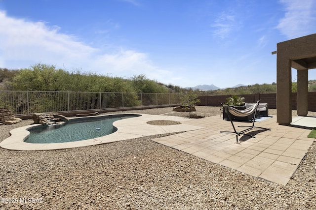 view of swimming pool featuring a patio area, a fenced in pool, a mountain view, a fenced backyard, and an outdoor fire pit