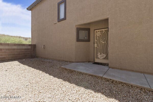 exterior space with fence and stucco siding