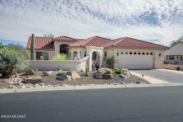 61867 E Ironwood Ln, Tucson, AZ 85739 - mediterranean / spanish-style house with fence private yard, an attached garage, stucco siding, and a tiled roof