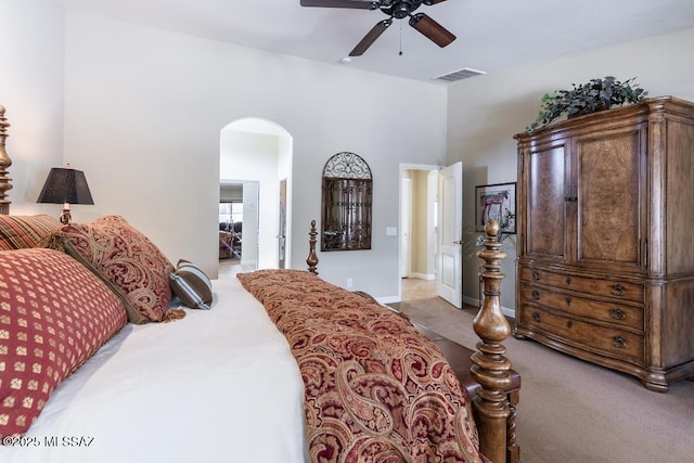61867 E Ironwood Ln, Tucson, AZ 85739 - carpeted bedroom featuring visible vents, arched walkways, and a ceiling fan