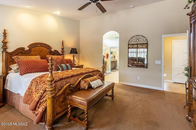 61867 E Ironwood Ln, Tucson, AZ 85739 - carpeted bedroom featuring connected bathroom, arched walkways, recessed lighting, baseboards, and a ceiling fan