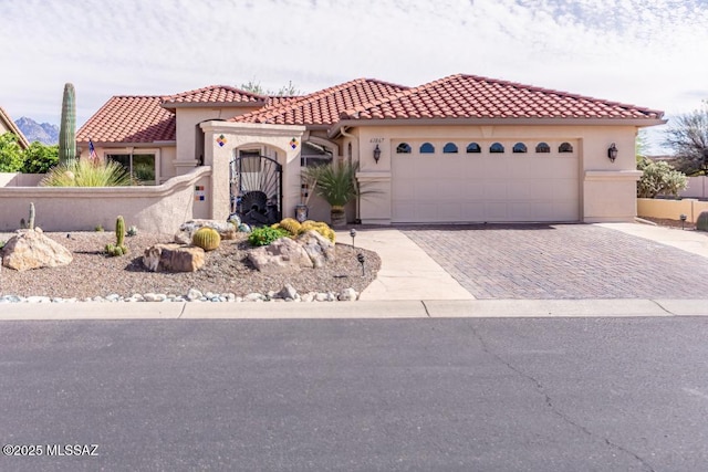 61867 E Ironwood Ln, Tucson, AZ 85739 - mediterranean / spanish-style house featuring stucco siding, a tiled roof, driveway, and a garage