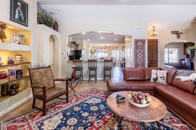 61867 E Ironwood Ln, Tucson, AZ 85739 - living room featuring arched walkways, baseboards, visible vents, and a healthy amount of sunlight