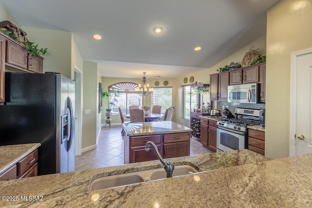 61867 E Ironwood Ln, Tucson, AZ 85739 - kitchen with a sink, a chandelier, light stone countertops, and stainless steel appliances