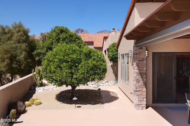 view of patio / terrace with a mountain view and fence