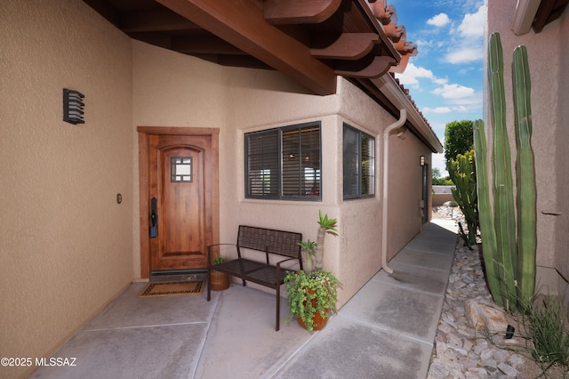 doorway to property with stucco siding