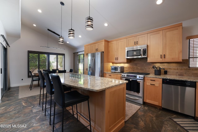 kitchen featuring light brown cabinetry, a kitchen island, recessed lighting, and appliances with stainless steel finishes