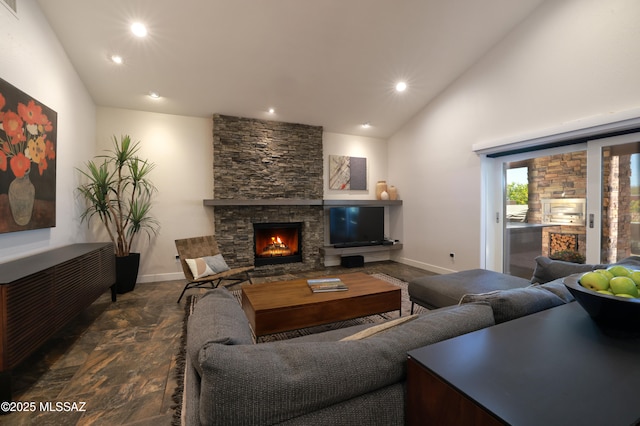 living area featuring recessed lighting, a stone fireplace, lofted ceiling, and baseboards
