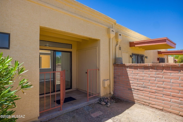 10127 E Achi, Tucson, AZ 85748 - doorway to property with stucco siding and fence