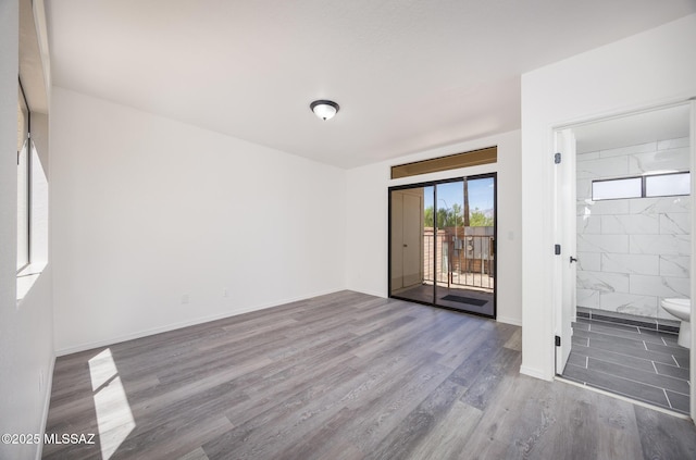 10127 E Achi, Tucson, AZ 85748 - unfurnished bedroom featuring access to outside, wood finished floors, ensuite bathroom, and baseboards