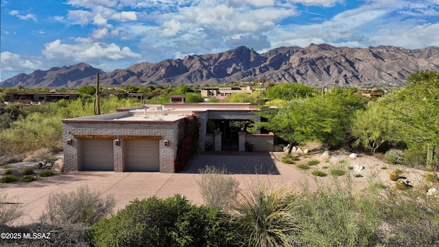 4915 N Via De La Granja, Tucson, AZ 85718 - view of front facade featuring brick siding, a mountain view, driveway, and an attached garage