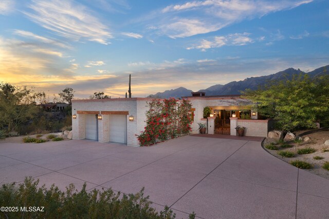 4915 N Via De La Granja, Tucson, AZ 85718 - view of front facade featuring a mountain view, brick siding, and a garage