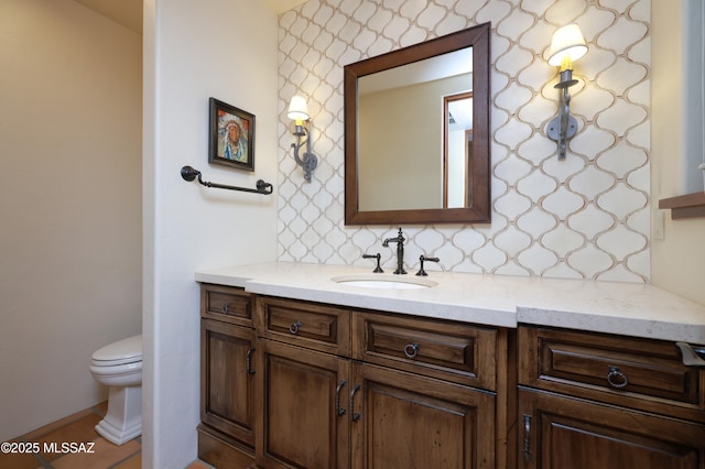 4915 N Via De La Granja, Tucson, AZ 85718 - bathroom featuring vanity, toilet, and decorative backsplash