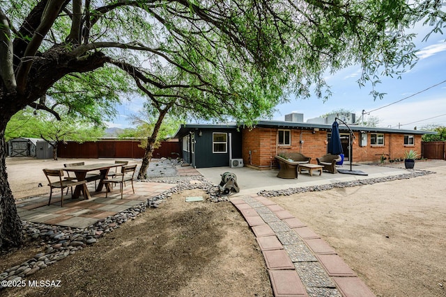 1652 W Roller Coaster Rd, Tucson, AZ 85704 - back of property with a fenced backyard, an outbuilding, a storage shed, and a patio