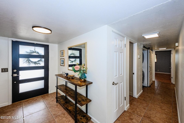 1652 W Roller Coaster Rd, Tucson, AZ 85704 - foyer featuring baseboards, tile patterned flooring, a textured ceiling, and a barn door