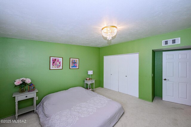 1652 W Roller Coaster Rd, Tucson, AZ 85704 - carpeted bedroom featuring visible vents, a textured ceiling, a notable chandelier, and a closet