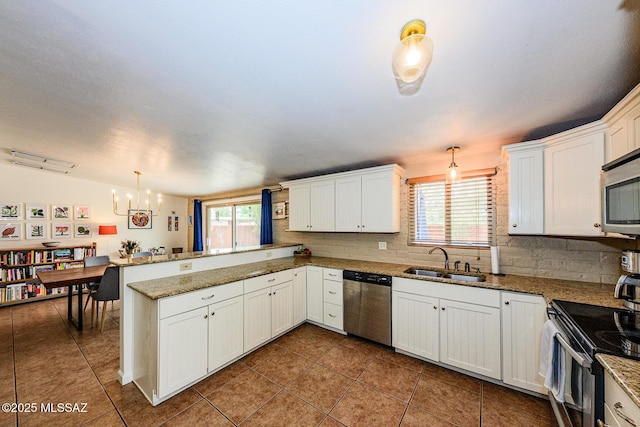 1652 W Roller Coaster Rd, Tucson, AZ 85704 - kitchen with a chandelier, stainless steel appliances, a sink, a peninsula, and white cabinetry