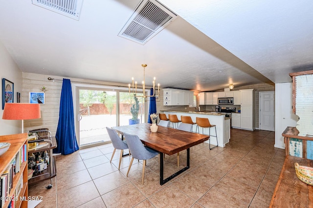 1652 W Roller Coaster Rd, Tucson, AZ 85704 - dining space featuring an inviting chandelier, visible vents, and light tile patterned floors