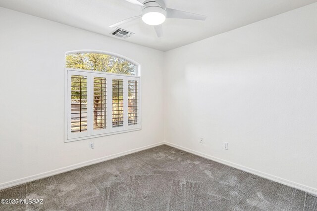 carpeted spare room with ceiling fan, baseboards, and visible vents