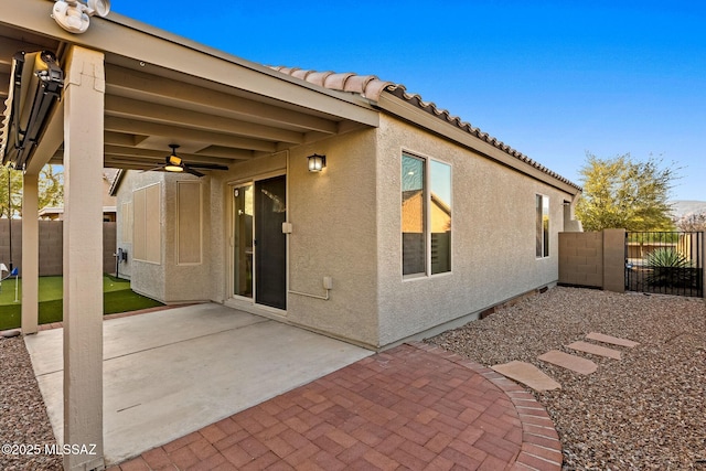 back of property featuring fence private yard, a patio, stucco siding, and a ceiling fan