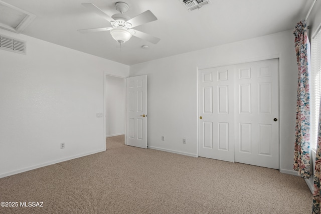 unfurnished bedroom featuring attic access, visible vents, and carpet
