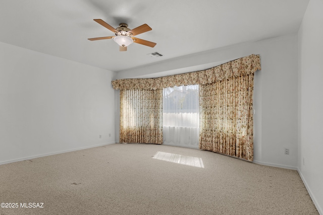 spare room featuring visible vents, ceiling fan, baseboards, and carpet floors