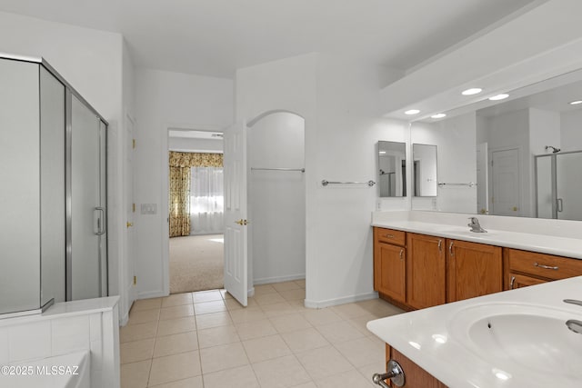 full bath with a shower stall, tile patterned floors, vanity, and baseboards