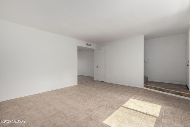 5850 S Del Moral Blvd, Tucson, AZ 85706 - spare room featuring baseboards and visible vents