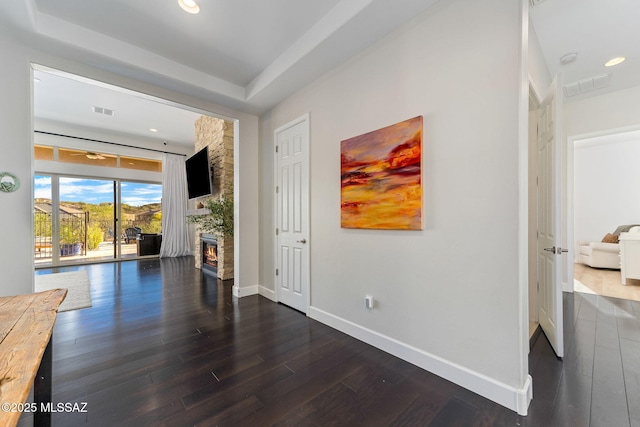 interior space featuring baseboards, wood finished floors, visible vents, and recessed lighting