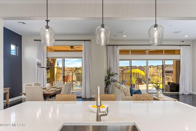 kitchen with plenty of natural light, visible vents, and open floor plan