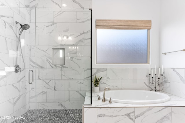 bathroom featuring a bath and a stall shower