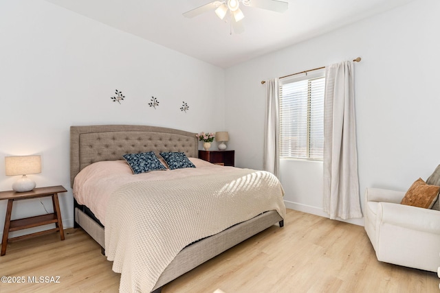 bedroom featuring baseboards, a ceiling fan, and light wood-style floors