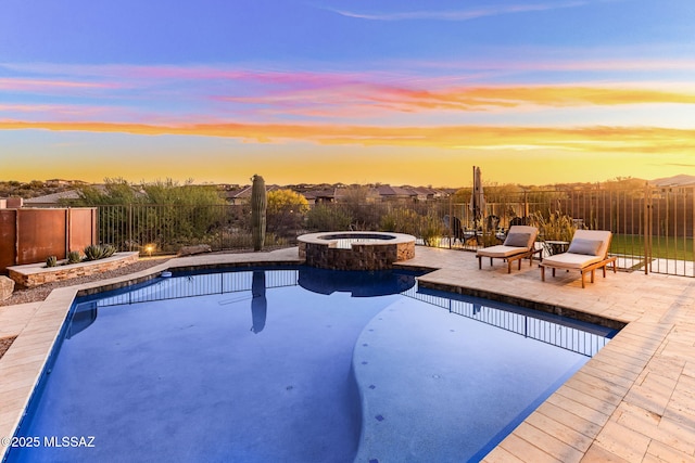 view of swimming pool featuring a fenced backyard, a pool with connected hot tub, and a patio