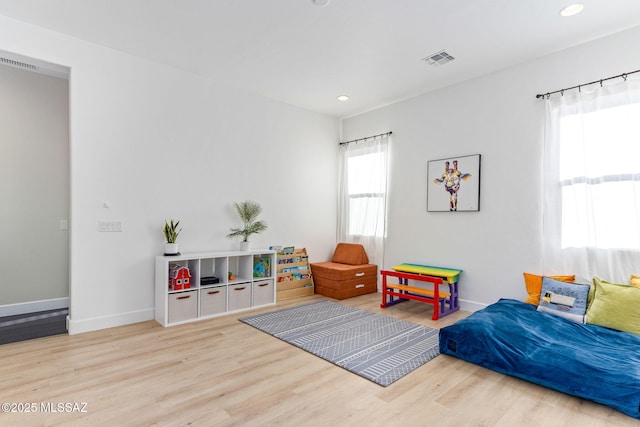 interior space with recessed lighting, wood finished floors, visible vents, and baseboards