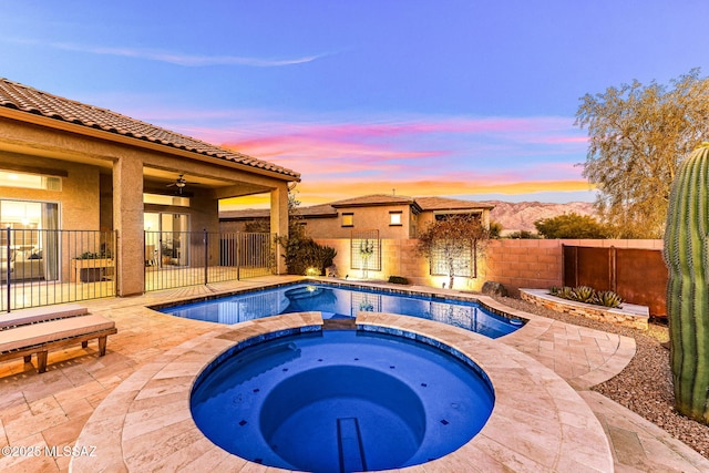 view of pool featuring a patio area, a fenced backyard, a fenced in pool, and an in ground hot tub