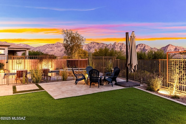 view of yard with a fenced backyard, a mountain view, and a patio area
