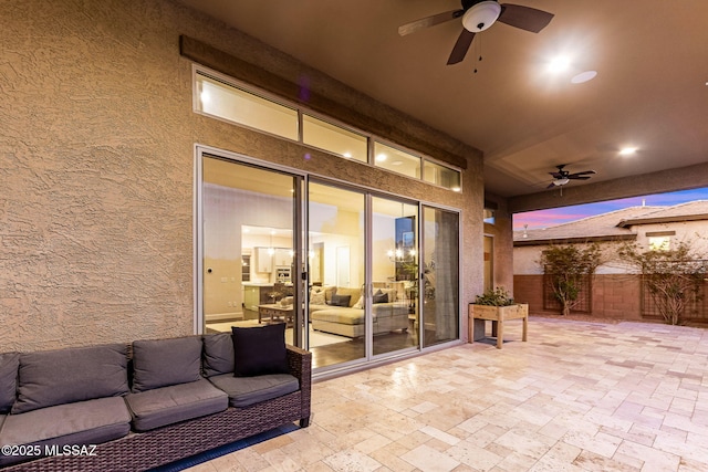 view of patio / terrace with fence, an outdoor living space, and ceiling fan