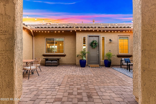 exterior space featuring stucco siding and a patio